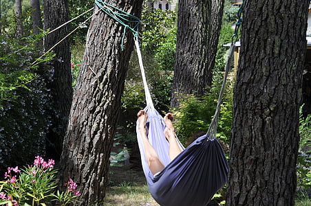 person lying down on blue hammock thumbnail