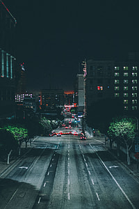 gray concrete street in the middle of buildings thumbnail