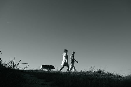 grayscale photography of man and woman walking thumbnail