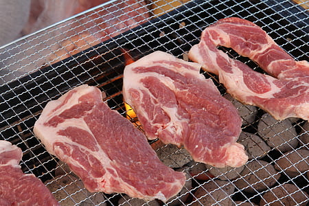 three sliced raw meat on gray grill thumbnail