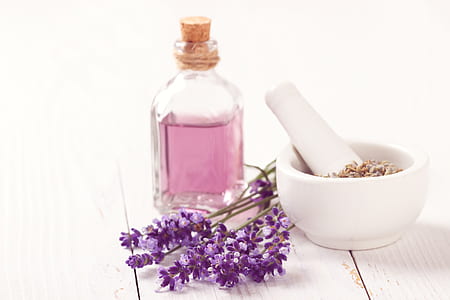 white marble mortar and pestle beside glass bottle thumbnail