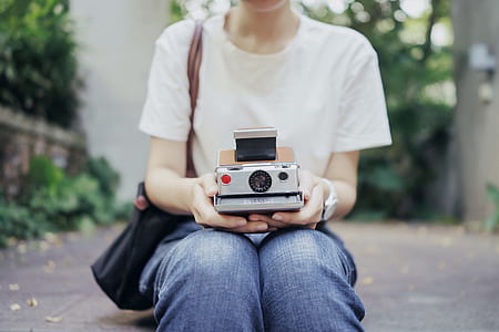 person sitting holding camera thumbnail