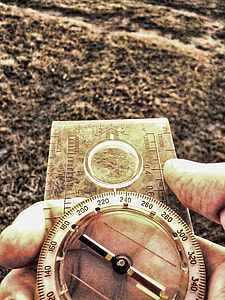 person holding compass thumbnail