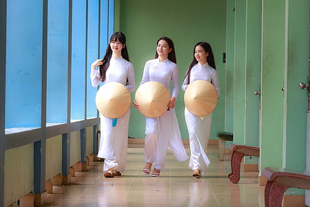 photo of three women wearing white long-sleeved dresses thumbnail