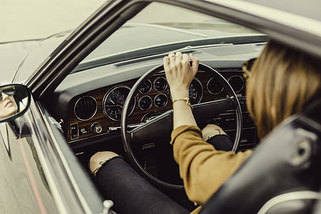 person sits and holds vehicle steering wheel thumbnail