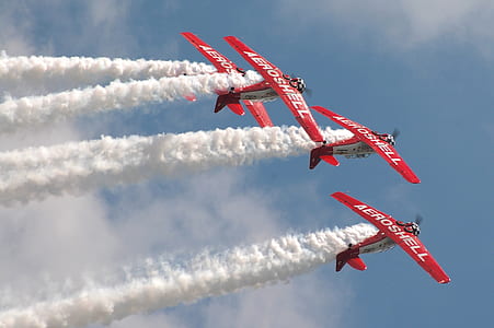red biplanes making trail thumbnail