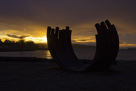 silhouette photography of structure near body of water thumbnail