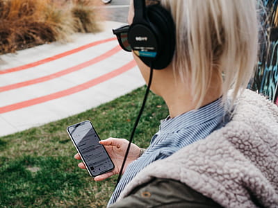 blonde haired person listening to music using corded headphones thumbnail