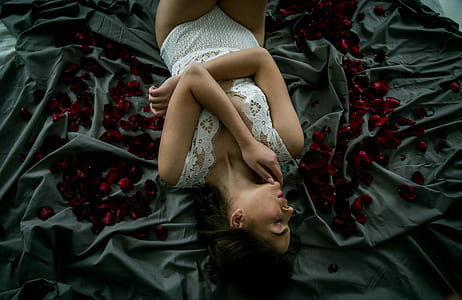 woman wearing white top sleeping on gray textile thumbnail