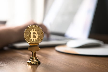 gold-color Bitcoin on brown surface thumbnail