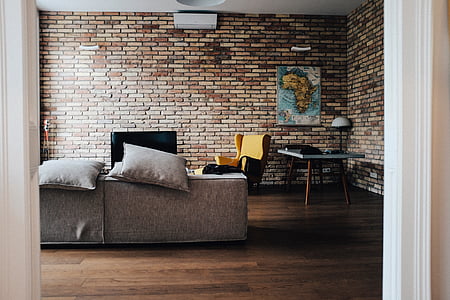 gray fabric sofa near flat screen TV turned-off thumbnail