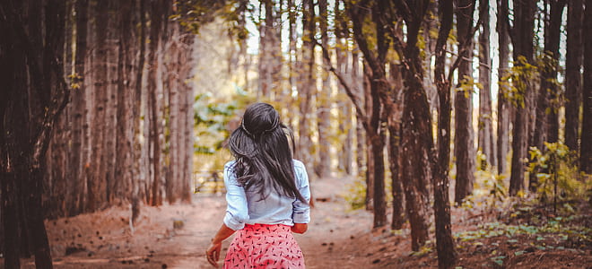 woman running near trees thumbnail