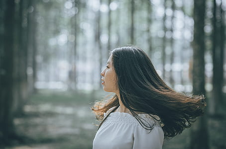 Woman in White Off-shoulder Dress Near Trees thumbnail