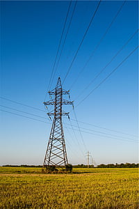 transmission tower on grass field thumbnail