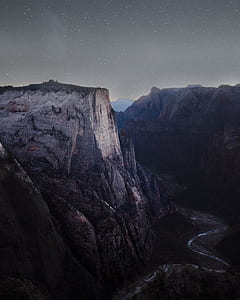 gray mountain near river under starry sky thumbnail