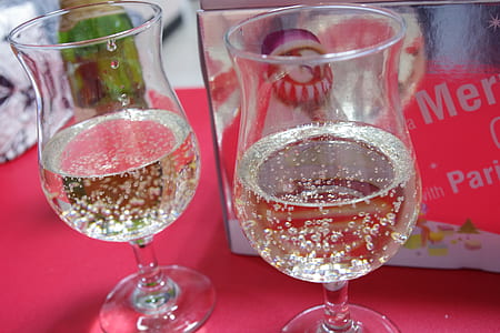 two clear footed glasses on red surface thumbnail
