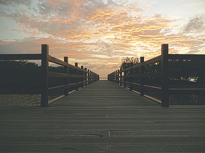 photo of gray wooden bridge during golden hour thumbnail