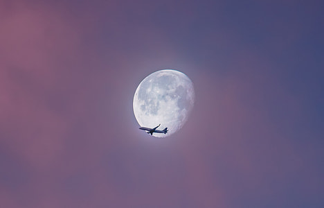 airplane under moon on sky thumbnail