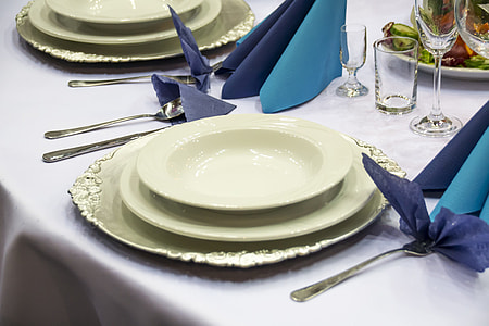 round white ceramic plate on table with spoon and fork thumbnail