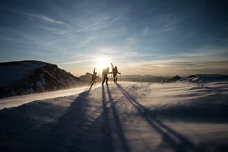 three person walking on snow thumbnail