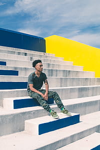 person sitting on arena concrete seats during daytime thumbnail