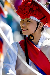 selective focus photography of woman wearing hat during parade outdoors thumbnail