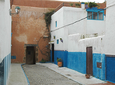 closed brown door in blue building at daytime thumbnail