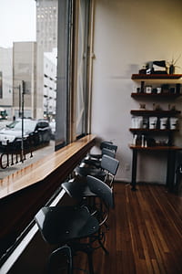 brown wooden desk beside black tables thumbnail