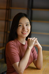 woman sitting beside wooden desk thumbnail
