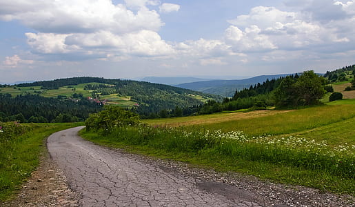 empty gray dirt country road during day thumbnail