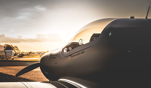 gray plane on port at sunset thumbnail