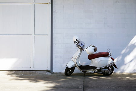 white helmet on top of red and white motor scooter thumbnail