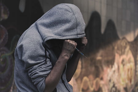 person wearing grey hoodie and holding rod thumbnail