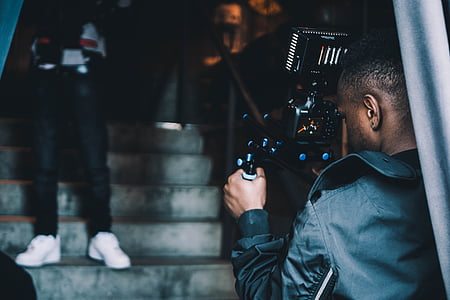 man holding black DSLR camera thumbnail