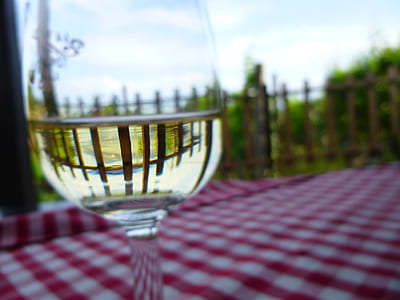 selective focus photography of clear wine glass near fence thumbnail