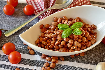 white ceramic bowl of nuts with stainless steel spoon beside thumbnail