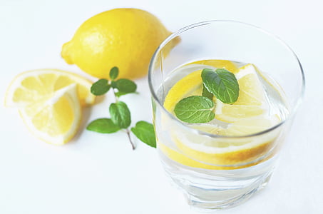 clear liquid inside clear glass with sliced of lemon fruit thumbnail