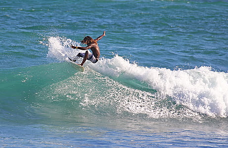 man surfing on body of water thumbnail