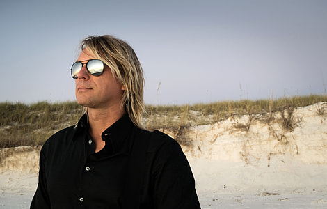 photo of man wearing flushed lens sunglasses at the back of green grasses thumbnail