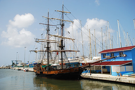 black and brown galleon on body of water thumbnail