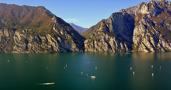 high angle photo of body of water near mountain range thumbnail