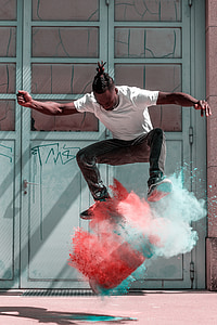 man doing skateboard stunts with blue and orange powder thumbnail