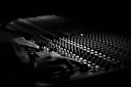 person adjusting audio mixers thumbnail