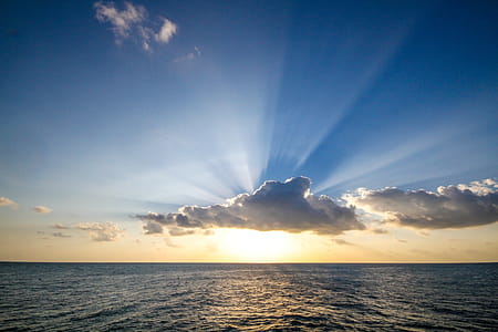 Sun Setting Over Ocean Photo thumbnail