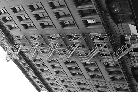 gray escape ladder ladder mounted on the side of the building thumbnail