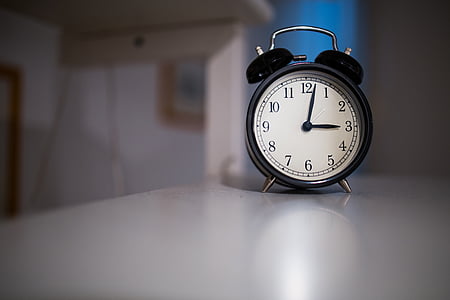 black alarm clock on table thumbnail