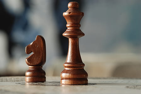 shallow focus photography of horse and queen chess pieces thumbnail