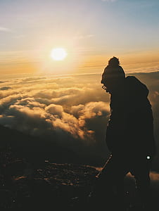 man walking on top of mountain during daytime thumbnail