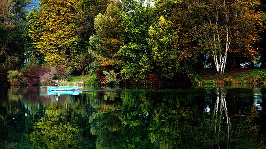 Blue Boat on Sail on Calm Body of Water during Daytime thumbnail