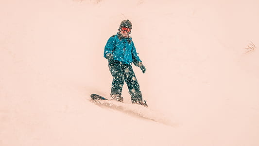 man riding snow board on snow path thumbnail